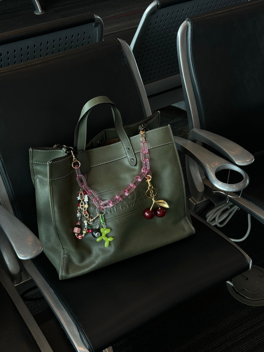 Jewerly charm pendant clipped on a purse zipper under soft daylight on neutral leather – purse charms for her Canada by BeCharmy